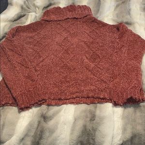 Burnt orange turtleneck sweater.